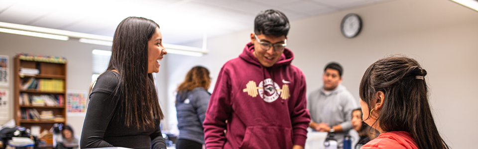 Students laughing together in a classroom